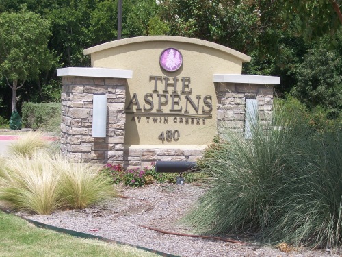 This sign located at 480 Bray Central Drive in Allen, Texas 75013 next to the driveway identifies The Aspens at Twin Creeks. This is an active adult community. 